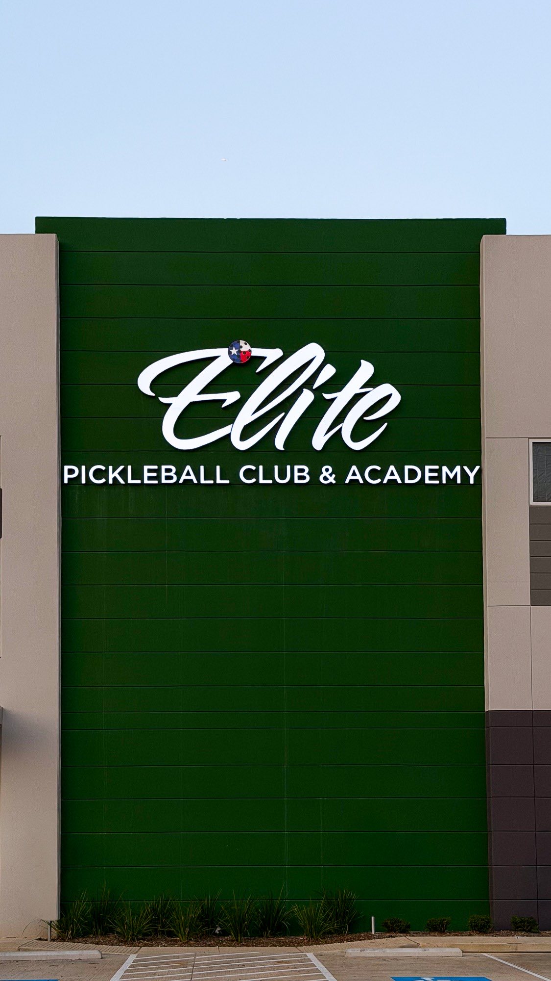Elite Pickleball Club and Academy dimensional letter sign on a green wall