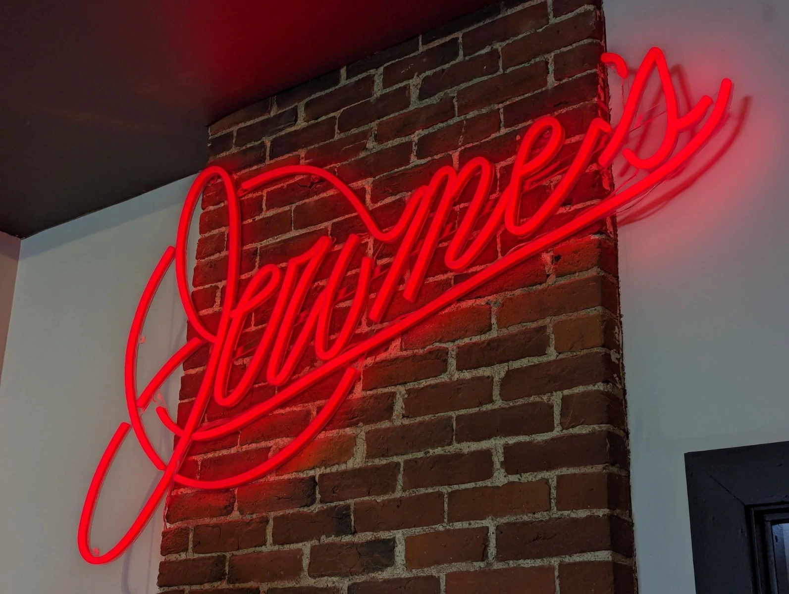 Red LED neon sign on a brick wall
