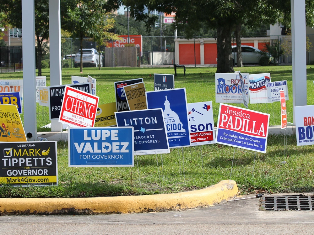 Campaign yard signs staked in a lawn