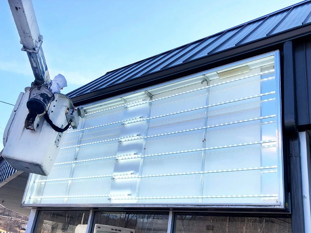 LED-lit sign face being serviced